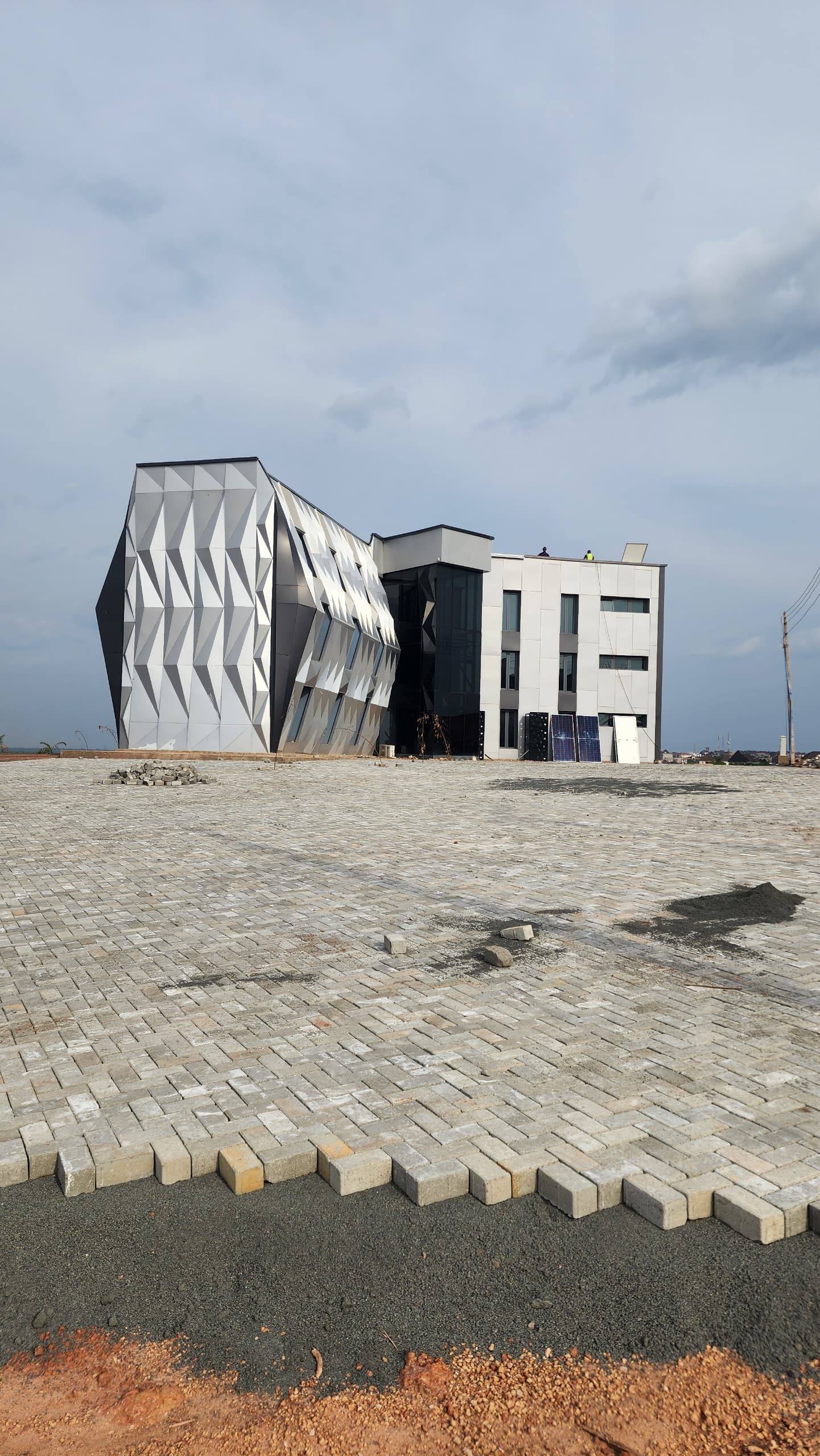 Faceted metal-clad commercial building under construction